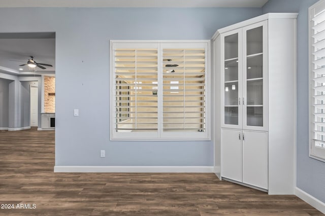 spare room featuring ceiling fan and dark wood-type flooring