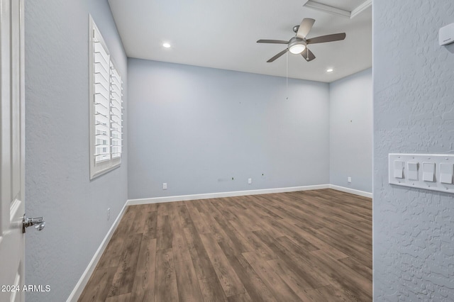 empty room with a healthy amount of sunlight and dark wood-type flooring