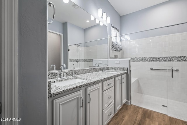 bathroom with vanity, hardwood / wood-style flooring, and walk in shower