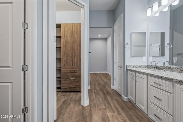 bathroom with vanity and hardwood / wood-style flooring