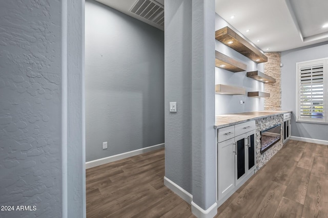 kitchen featuring white cabinets and dark wood-type flooring