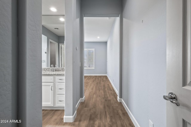 hall featuring sink and hardwood / wood-style flooring