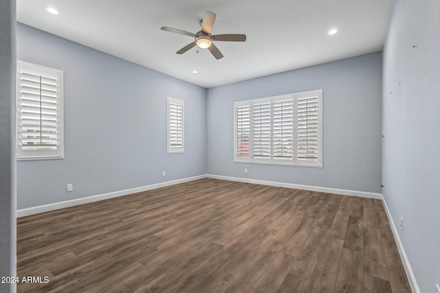 unfurnished room featuring ceiling fan and dark wood-type flooring