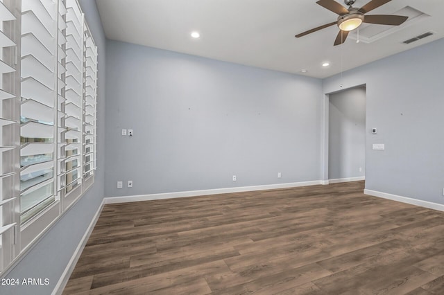 spare room with ceiling fan and dark hardwood / wood-style flooring