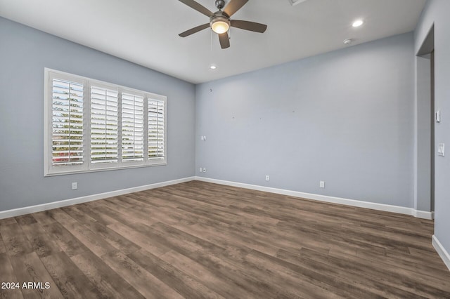 empty room featuring ceiling fan and dark hardwood / wood-style floors