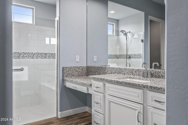 bathroom with vanity, an enclosed shower, and wood-type flooring