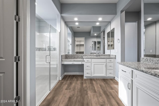 bathroom featuring vanity, wood-type flooring, and an enclosed shower