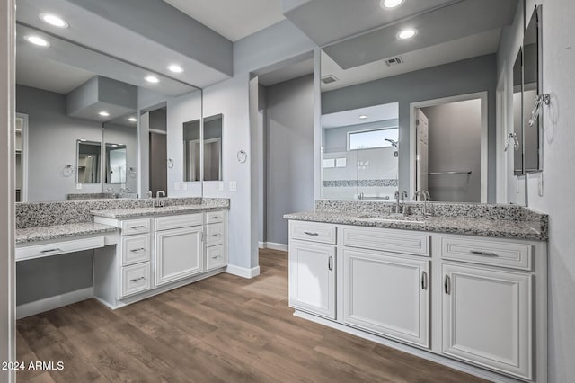 bathroom featuring a shower, wood-type flooring, and vanity