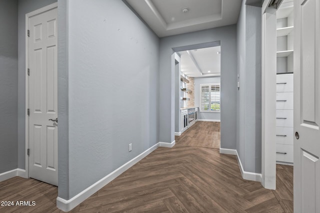 hallway with dark parquet flooring