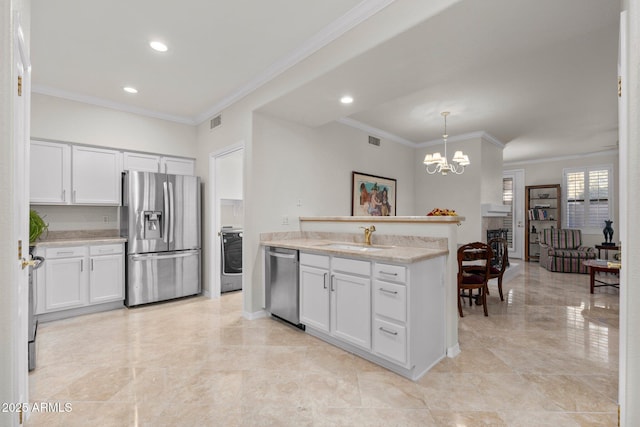 kitchen with sink, white cabinetry, decorative light fixtures, ornamental molding, and appliances with stainless steel finishes