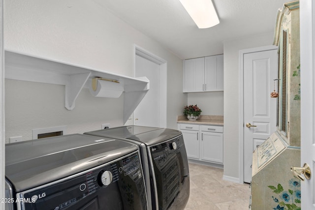 washroom featuring separate washer and dryer and cabinets