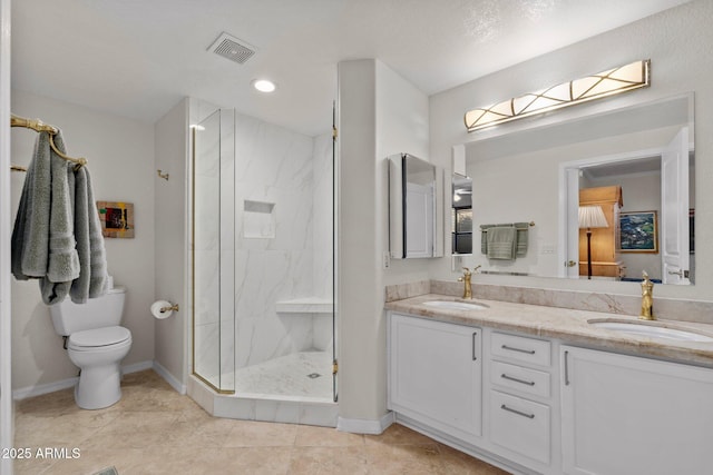 bathroom featuring vanity, tile patterned flooring, a shower with door, and toilet