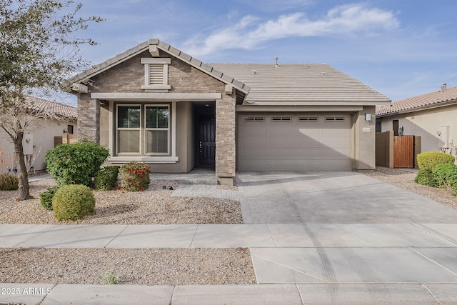 single story home with decorative driveway, stucco siding, an attached garage, fence, and a tiled roof