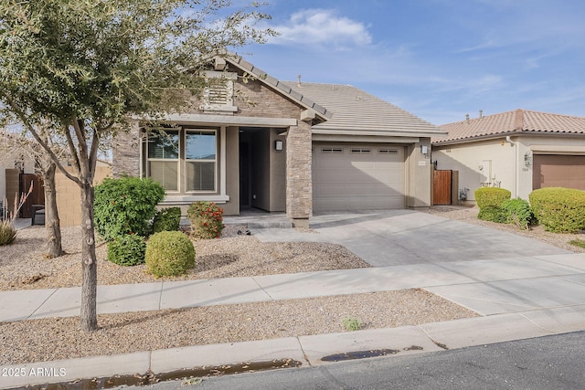 view of front of house with a garage, concrete driveway, a tiled roof, and stucco siding