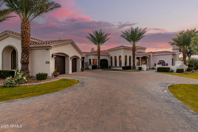 mediterranean / spanish house featuring a garage