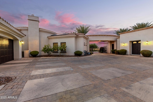 mediterranean / spanish home featuring a garage