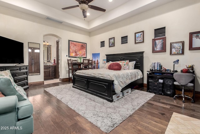 bedroom with dark hardwood / wood-style floors and ceiling fan