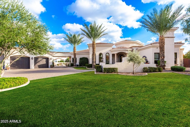 mediterranean / spanish-style house with a garage and a front lawn