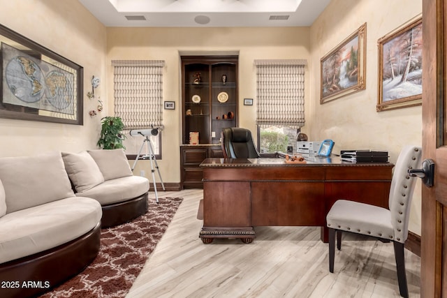 office with light hardwood / wood-style flooring