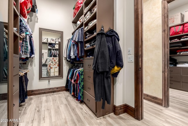 spacious closet with light hardwood / wood-style floors