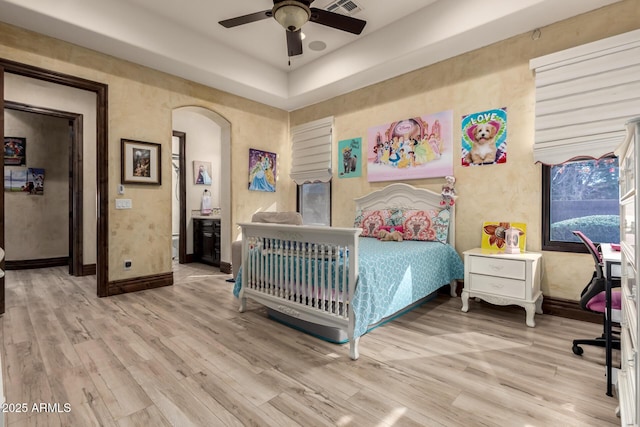 bedroom featuring light hardwood / wood-style flooring and ceiling fan