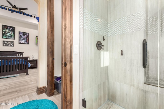 bathroom with an enclosed shower and ceiling fan