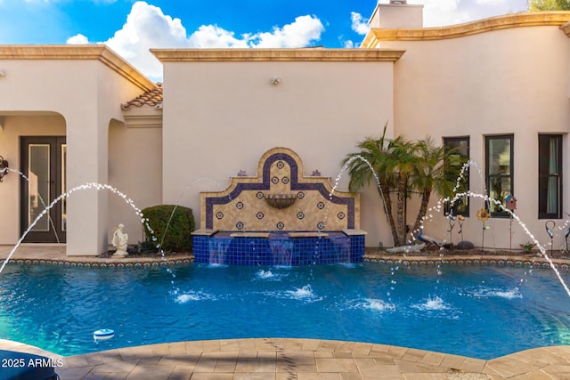 view of swimming pool featuring pool water feature