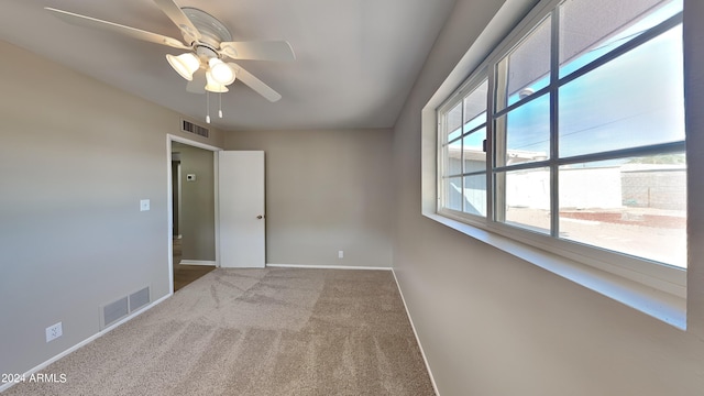 unfurnished room featuring carpet and ceiling fan