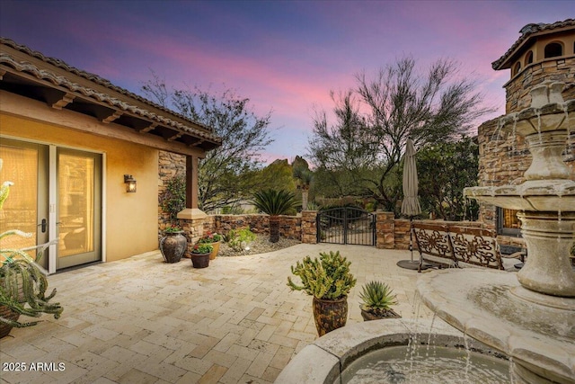 view of patio terrace at dusk