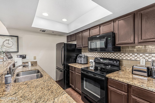 7777 E Main St Unit 143, Scottsdale, AZ 85251 - kitchen featuring black appliances, a sink, dark brown cabinetry, light stone counters, and backsplash