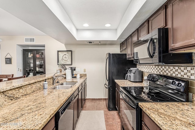 7777 E Main St Unit 143, Scottsdale, AZ 85251 - kitchen with black appliances, a sink, backsplash, light stone counters, and recessed lighting
