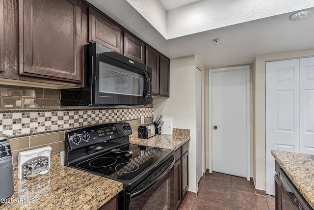 7777 E Main St Unit 143, Scottsdale, AZ 85251 - kitchen featuring black appliances, dark brown cabinets, backsplash, light stone countertops, and dark tile patterned flooring