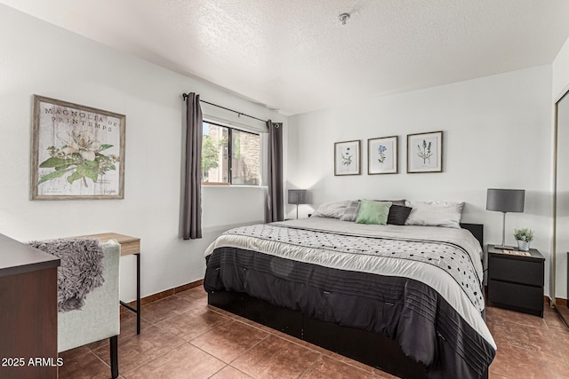 7777 E Main St Unit 143, Scottsdale, AZ 85251 - bedroom featuring a textured ceiling, tile patterned floors, and baseboards