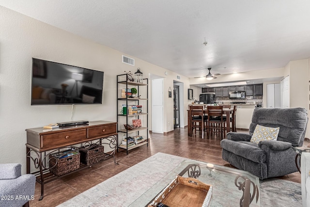 7777 E Main St Unit 143, Scottsdale, AZ 85251 - living room with a ceiling fan and dark tile patterned flooring