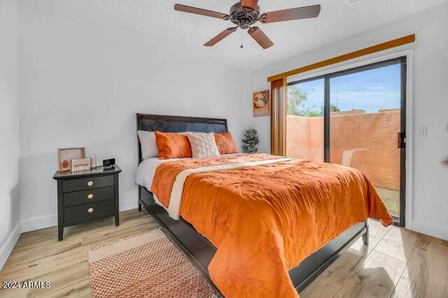 bedroom featuring ceiling fan, light hardwood / wood-style flooring, and access to exterior