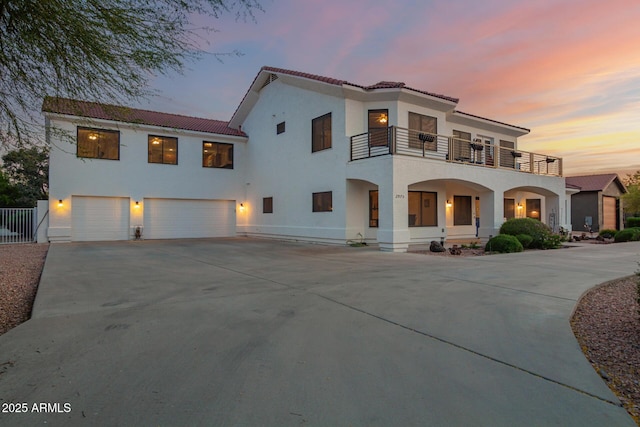 2075 W Silverlode Dr, Wickenburg, AZ 85390 - mediterranean / spanish-style home with a balcony, a garage, a tile roof, and stucco siding