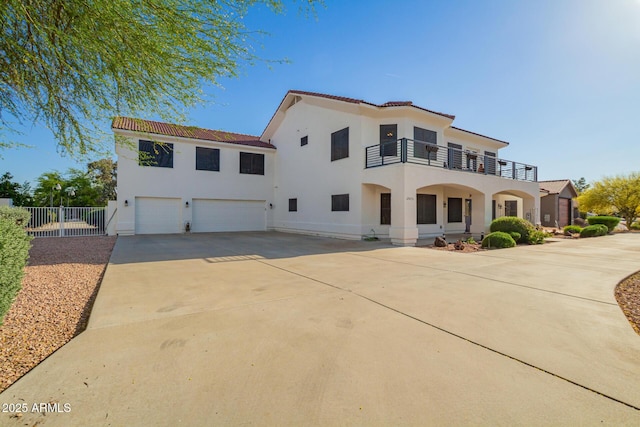 2075 W Silverlode Dr, Wickenburg, AZ 85390 - mediterranean / spanish house with a balcony, an attached garage, driveway, stucco siding, and fence