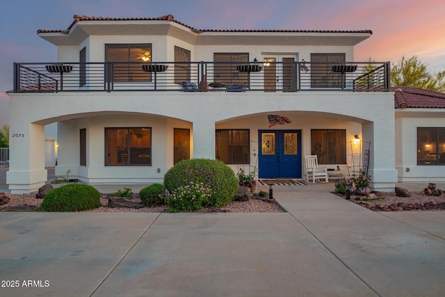 2075 W Silverlode Dr, Wickenburg, AZ 85390 - view of front of home featuring a balcony, covered porch, stucco siding, and a tiled roof