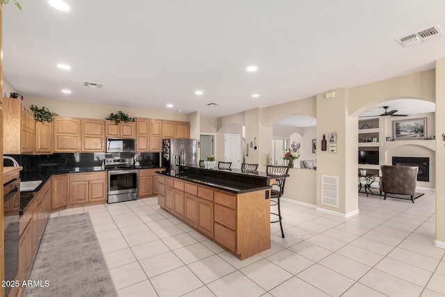 2075 W Silverlode Dr, Wickenburg, AZ 85390 - kitchen with appliances with stainless steel finishes, dark countertops, light tile patterned floors, and recessed lighting