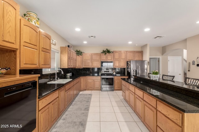 2075 W Silverlode Dr, Wickenburg, AZ 85390 - kitchen with appliances with stainless steel finishes, a sink, tasteful backsplash, arched walkways, and light tile patterned flooring