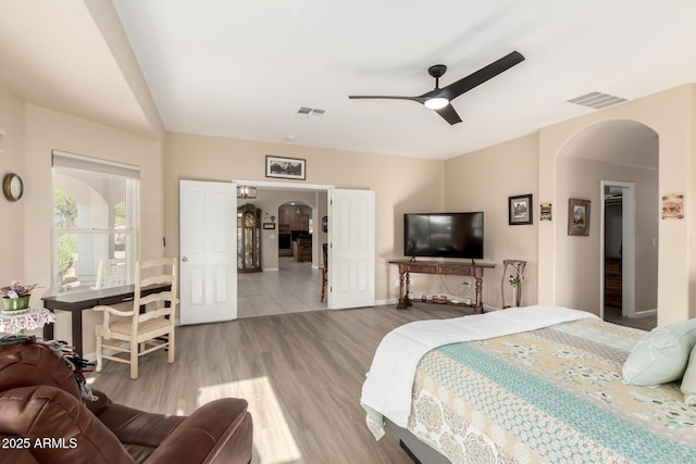 2075 W Silverlode Dr, Wickenburg, AZ 85390 - bedroom featuring arched walkways, light wood-style flooring, baseboards, and ceiling fan