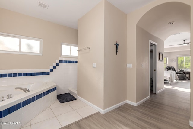 2075 W Silverlode Dr, Wickenburg, AZ 85390 - full bath featuring a garden tub, wood finished floors, a ceiling fan, and baseboards