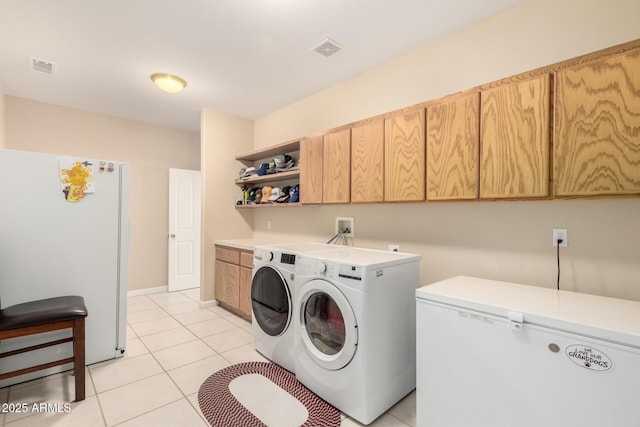 2075 W Silverlode Dr, Wickenburg, AZ 85390 - laundry area with independent washer and dryer, cabinet space, and light tile patterned floors
