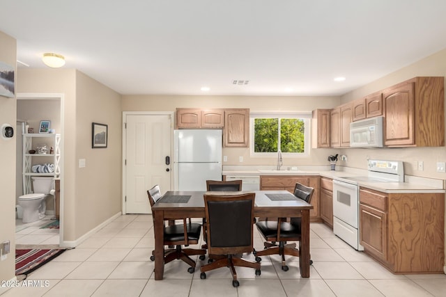 2075 W Silverlode Dr, Wickenburg, AZ 85390 - kitchen featuring white appliances, light countertops, a sink, light tile patterned floors, and recessed lighting