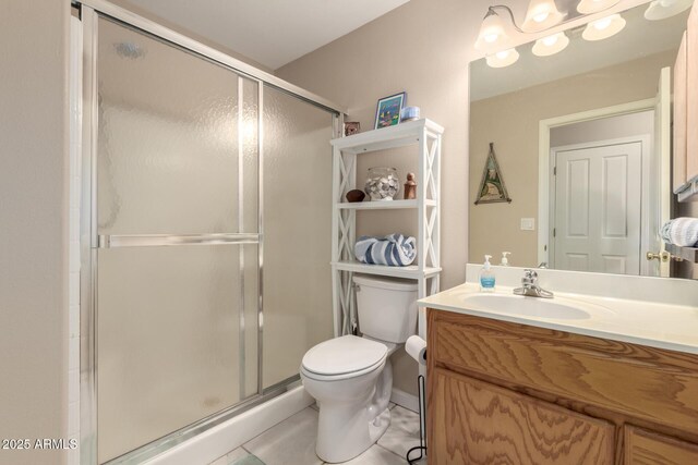 2075 W Silverlode Dr, Wickenburg, AZ 85390 - bathroom with a shower stall, toilet, vanity, and tile patterned flooring