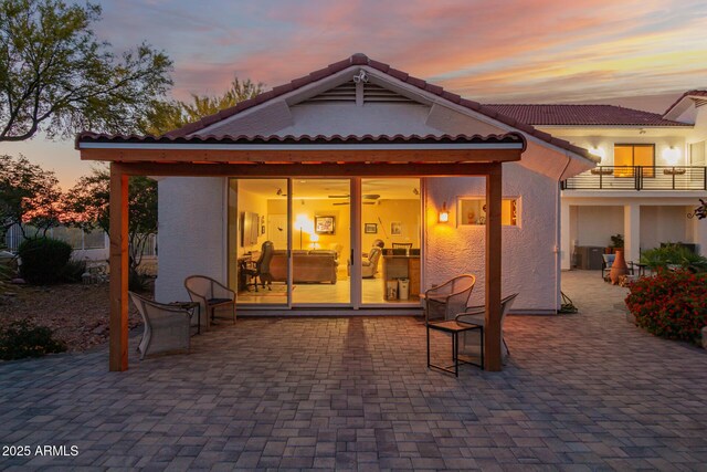 2075 W Silverlode Dr, Wickenburg, AZ 85390 - back of property with a patio area, stucco siding, and a tiled roof