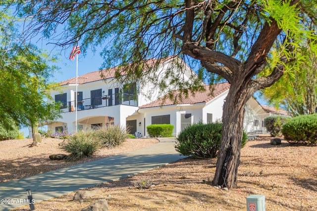 2075 W Silverlode Dr, Wickenburg, AZ 85390 - mediterranean / spanish home featuring a balcony, a tiled roof, and stucco siding