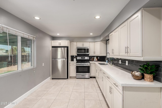 1747 W Devon, Mesa, AZ 85201 - kitchen with appliances with stainless steel finishes, decorative backsplash, light tile patterned floors, light countertops, and recessed lighting