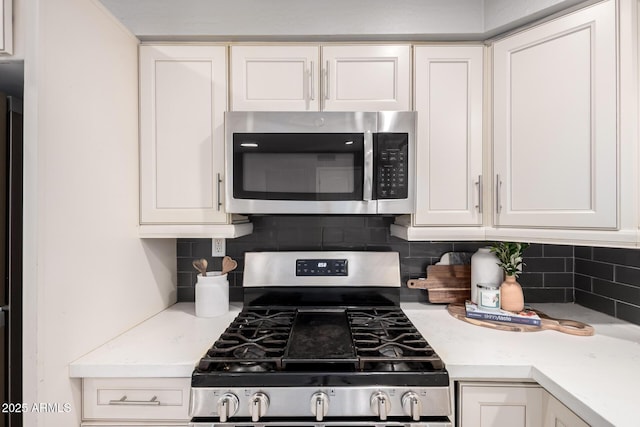 1747 W Devon, Mesa, AZ 85201 - kitchen with appliances with stainless steel finishes, white cabinets, light countertops, and tasteful backsplash