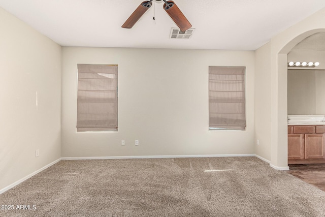 spare room featuring ceiling fan and carpet